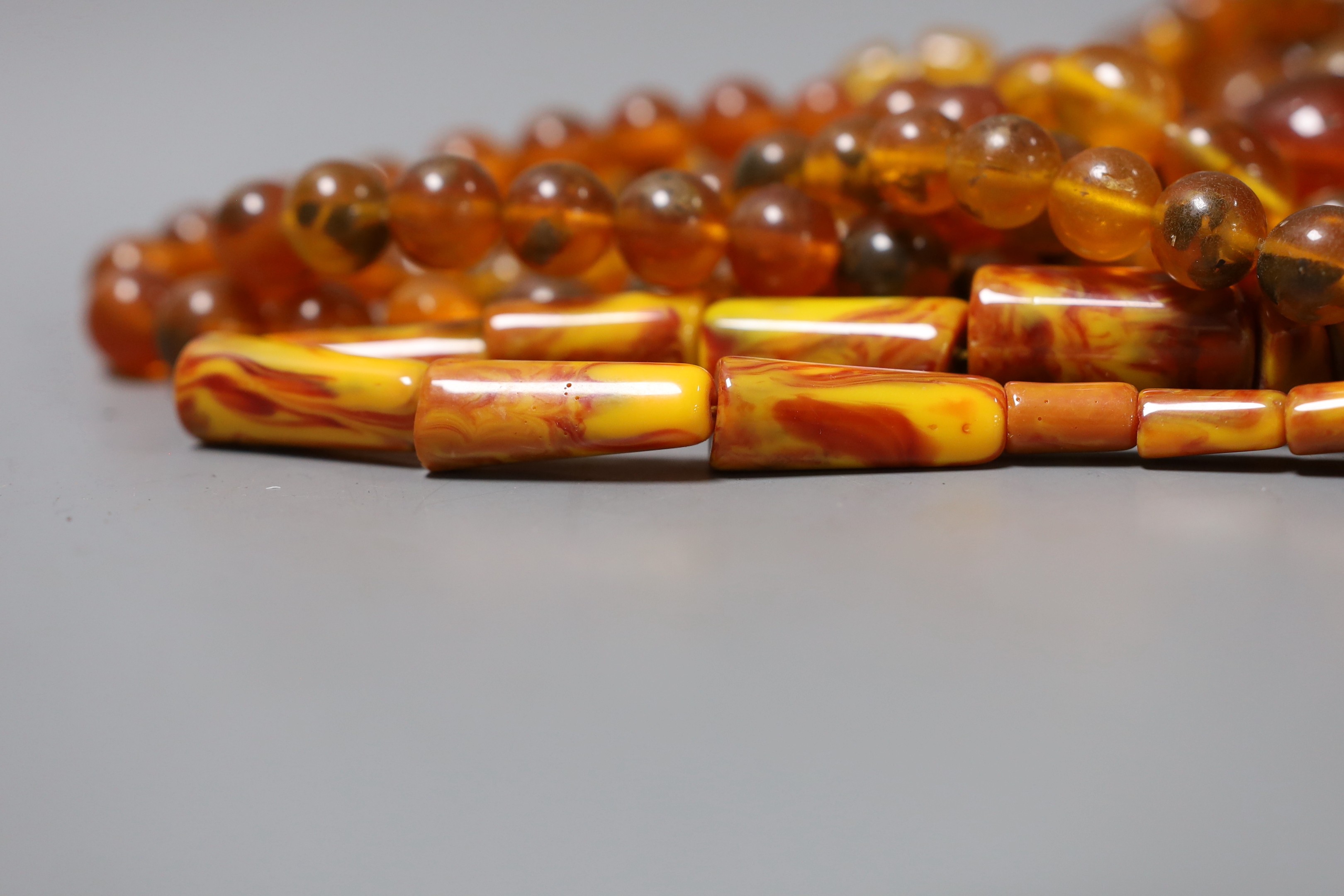 A group of amber and simulated amber bead necklaces (6).